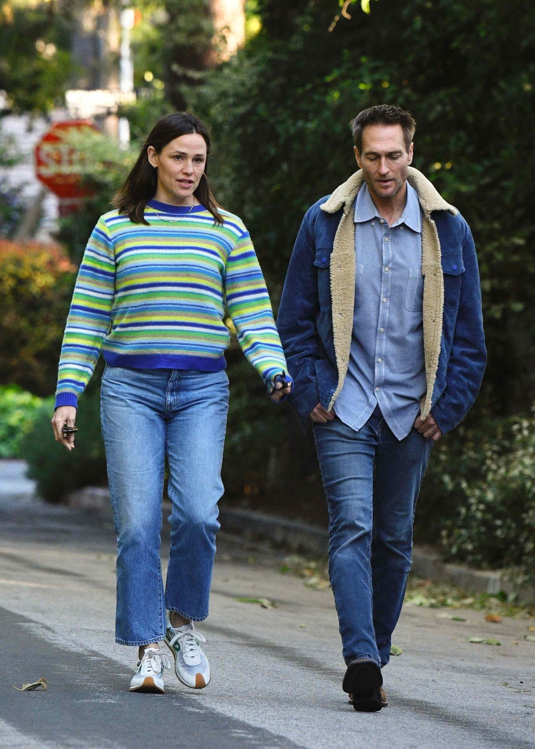 Jennifer Garner enjoys a leisurely evening stroll, engaging in a deep conversation with her boyfriend, John Miller, as they walk side by side through her neighborhood.