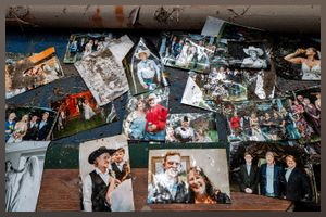 Salvaged photographs of the Rich family are displayed on a table in their home after it flooded on July 06, 2025 in Center Point, Texas. Heavy rainfall caused severe flooding along the Guadalupe River in central Texas, leaving more than 70 people reported dead